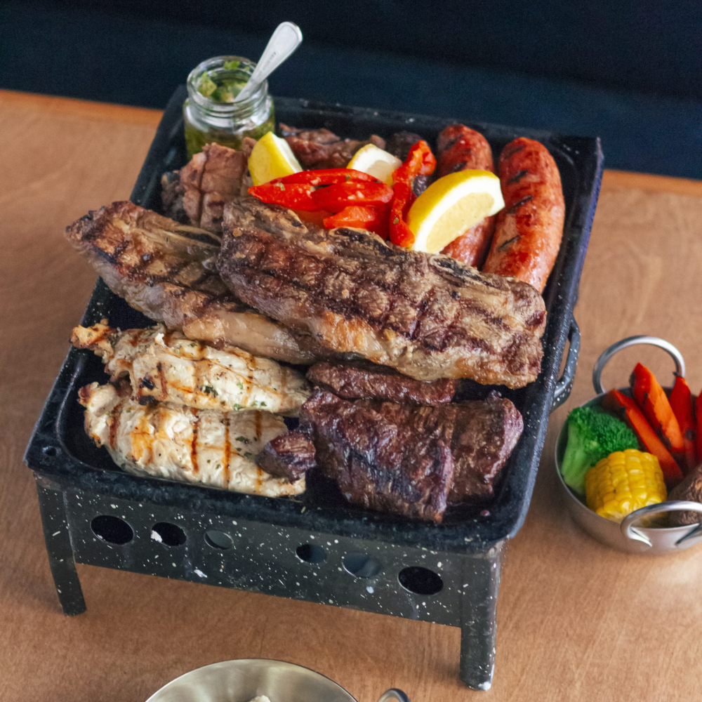 Our famous Argentinian Grill. Comes with skirt steak, short ribs, 2 chorizos, morcilla and mollejas. Served with two sides.