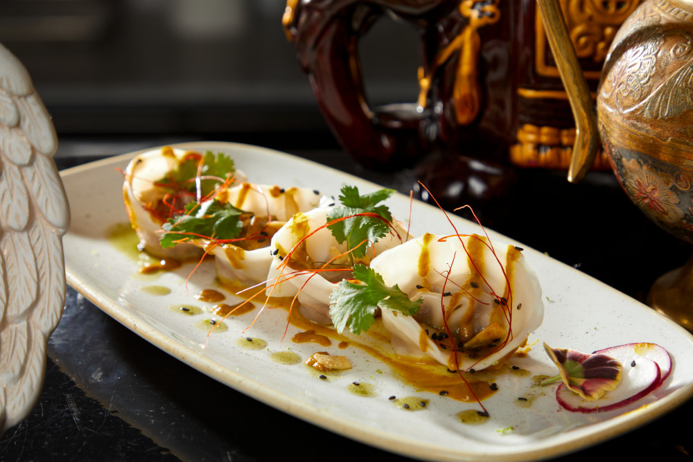 Steamed dumpling filled with roasted lamb on a curry spicy sauce