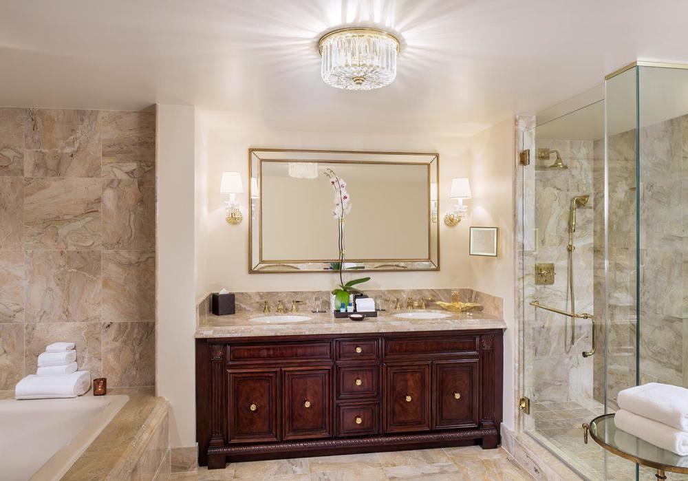 The luxurious Villa Deluxe bathrooms feature granite countertops, marble flooring and a frameless shower with rainfall shower head.