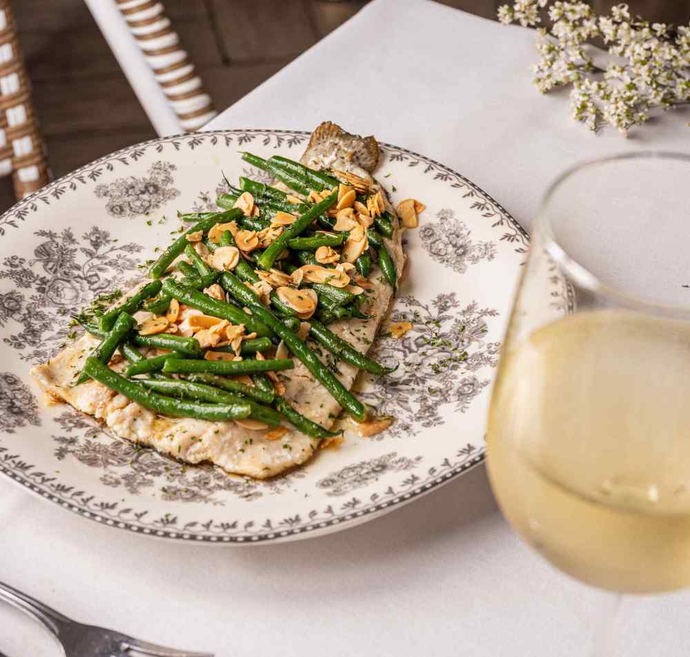 All-day flavors done right—fresh, vibrant plates and a glass of wine set the tone at Orange Blossom Miami Beach.
