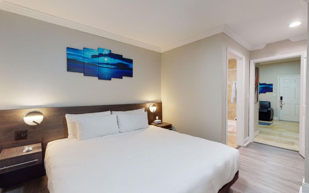 Executive King Suite bedroom. Room has full size kitchen and sofa bed