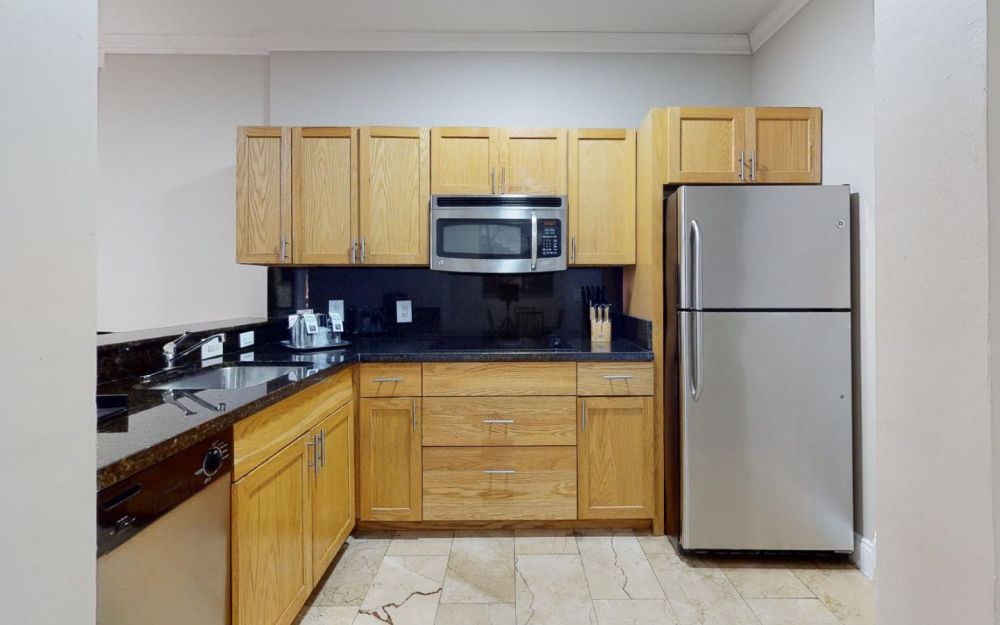 Full kitchen, dining room, living room, bedroom and balcony. Master King Suite