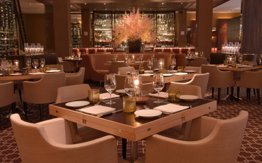 Chef Mina elevates steakhouse dishes with global flavors. The restaurant offers premium beef, seafood, wine program, and local ingredients.