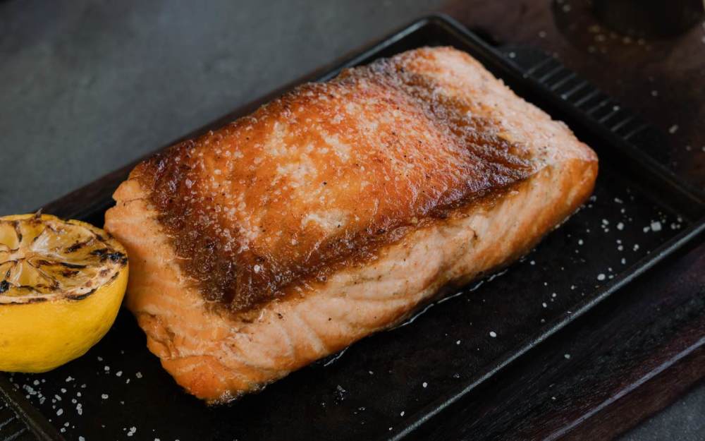 Faroe Island salmon, expertly grilled for a crisp, golden crust and tender, flaky center. Served with your side dish of your choice