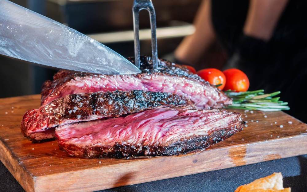 A richly marbled, tender cut known for its deep, beefy flavor. Marinated and grilled over open flame, served with chimichurri and your choice of sides