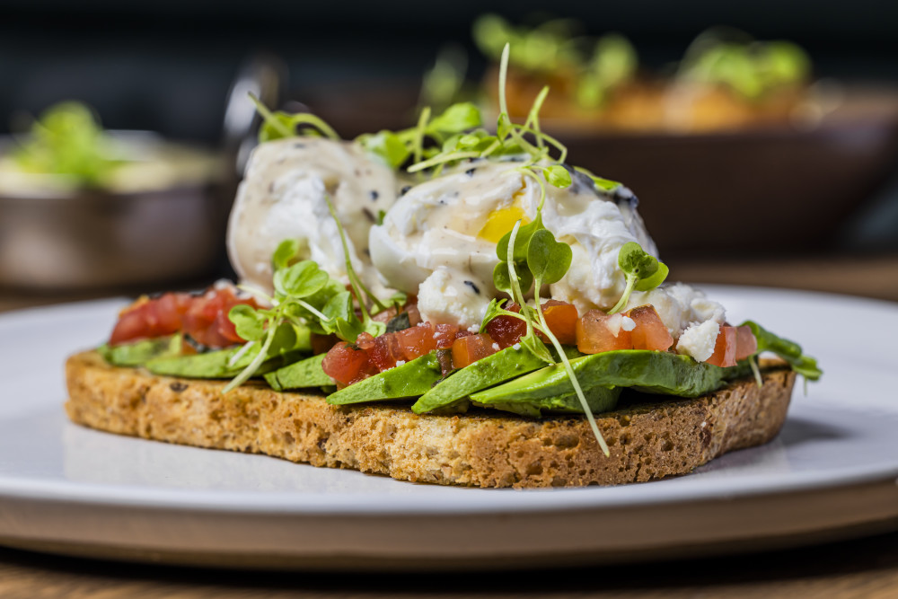 multi grain toast, sliced avocado, diced tomato, feta ,poached egg, truffle cream sauce
