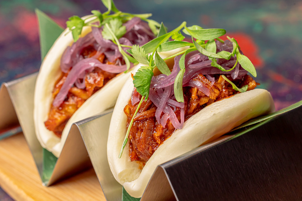 Shredded pork with home-made barbecue sauce, caramelized red onions on bao buns