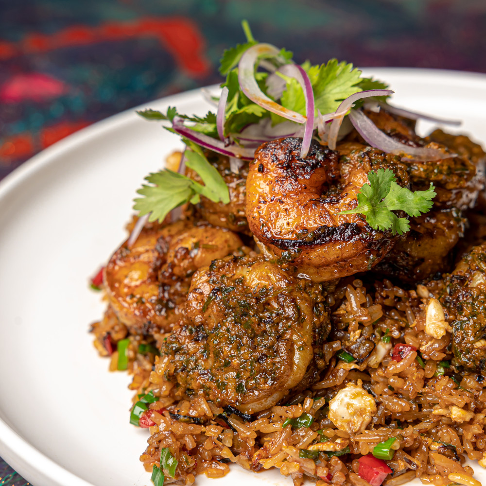 Peruvian-style rice wok with vegetables, eggs, red onions, cilantro, and Nikkei-style shrimp