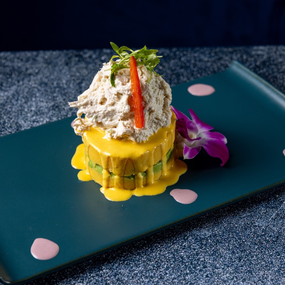 Causa de Pollo layers smooth yellow potato with seasoned shredded chicken, avocado, and a touch of lime. Creamy, fresh, and full of flavor.