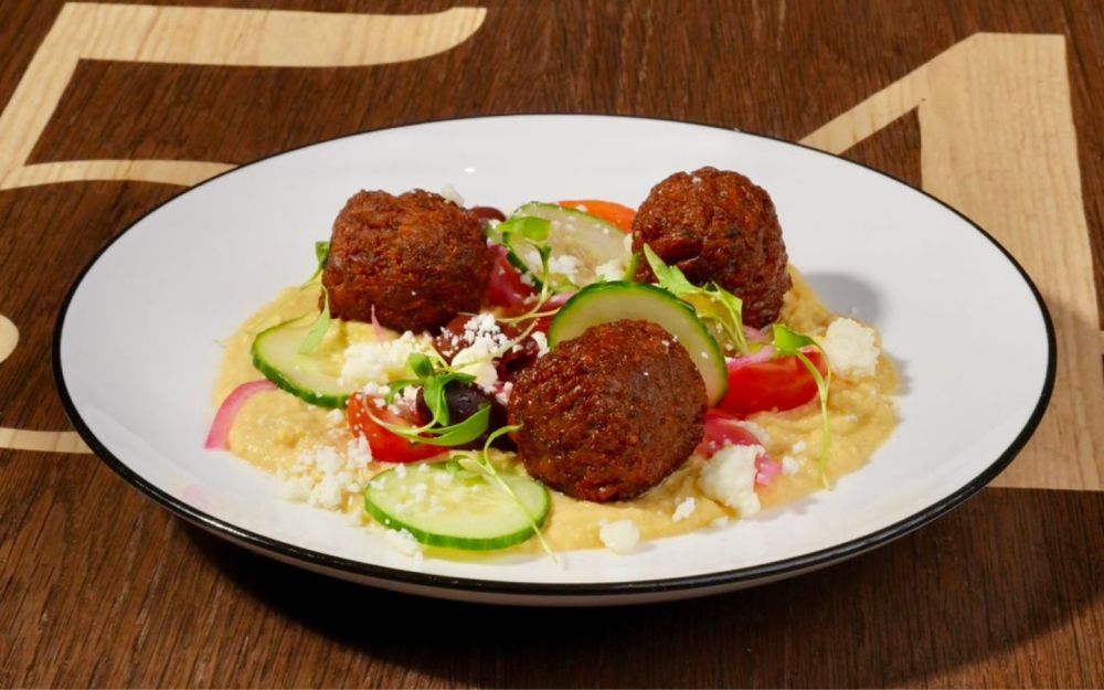 Crispy Falafel / 	Chickpeas Falafel ,hummus, grape tomatoes, cucumber, olives,  marinated red onions, feta cheese, micro cilantro.