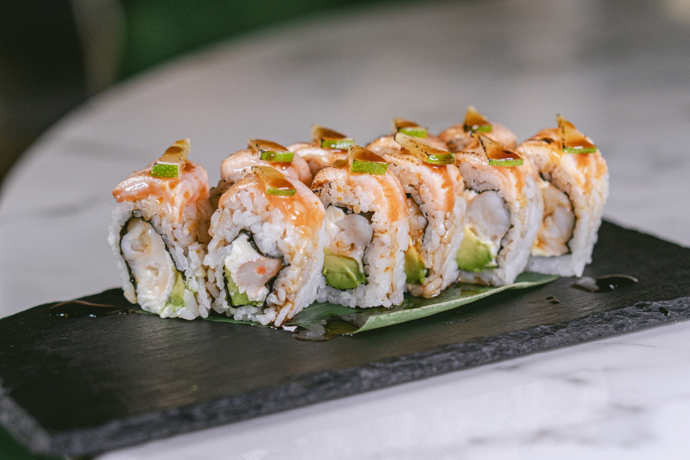 Shrimp, avocado, cream cheese, torched salmon on top, lime, teriyaki