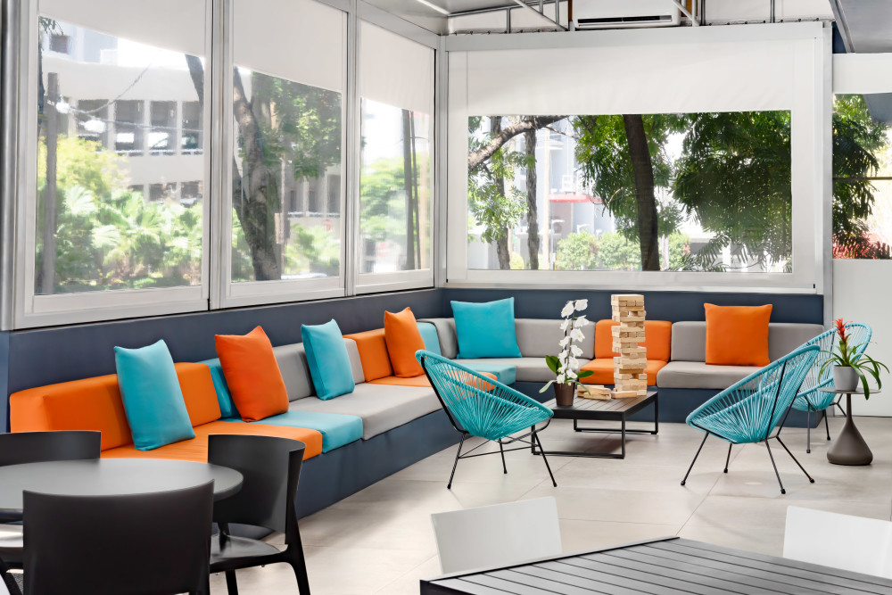 Kick back at Aloft Miami Brickell’s colorful patio—your easygoing Brickell Miami hangout for fresh air, good vibes, and laid-back city energy.