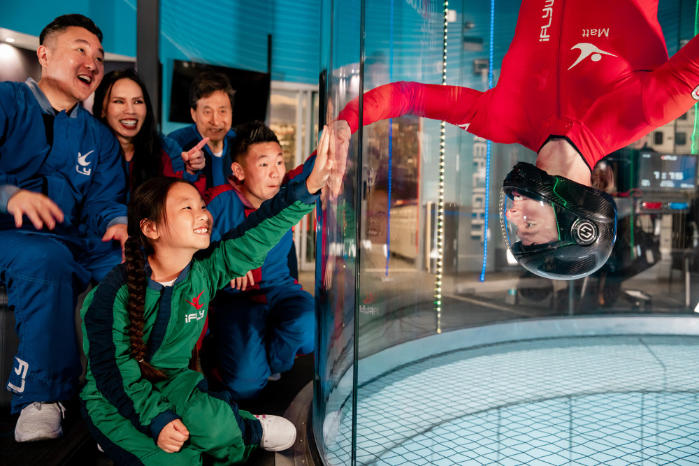 A flight instructor high fives students.