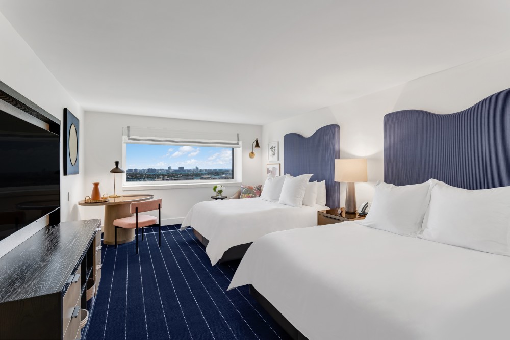 Stunning waterfront guest room decorated in a uniquely modern style that blends nature and marine inspired details.
