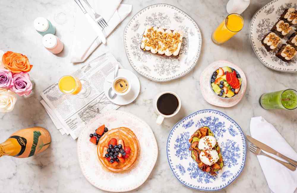 Brunch in style at Orange Blossom with vibrant pancakes, avocado toast, fresh fruit, and bubbly—Miami flavor meets laid-back setting.