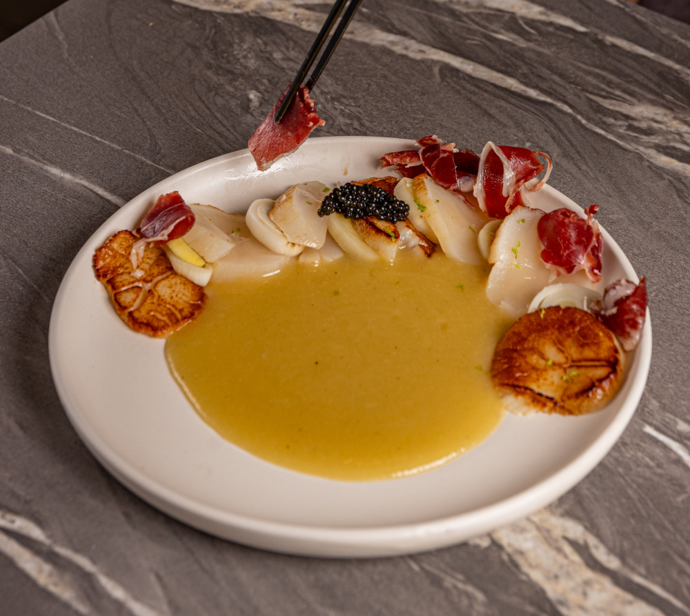 Creamy leek soup, pickled leeks, and 5J Iberian ham.