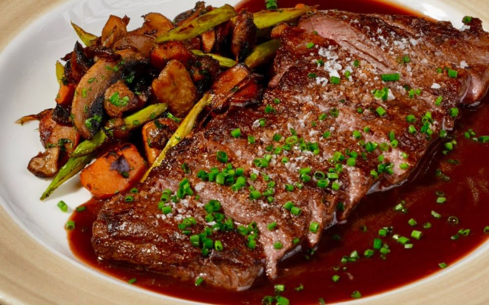Skirt Steak  / 10 oz Prime skirt steak,  mushrooms, red onion, sweet potato, asparagus sautéed, demi glace sauce.