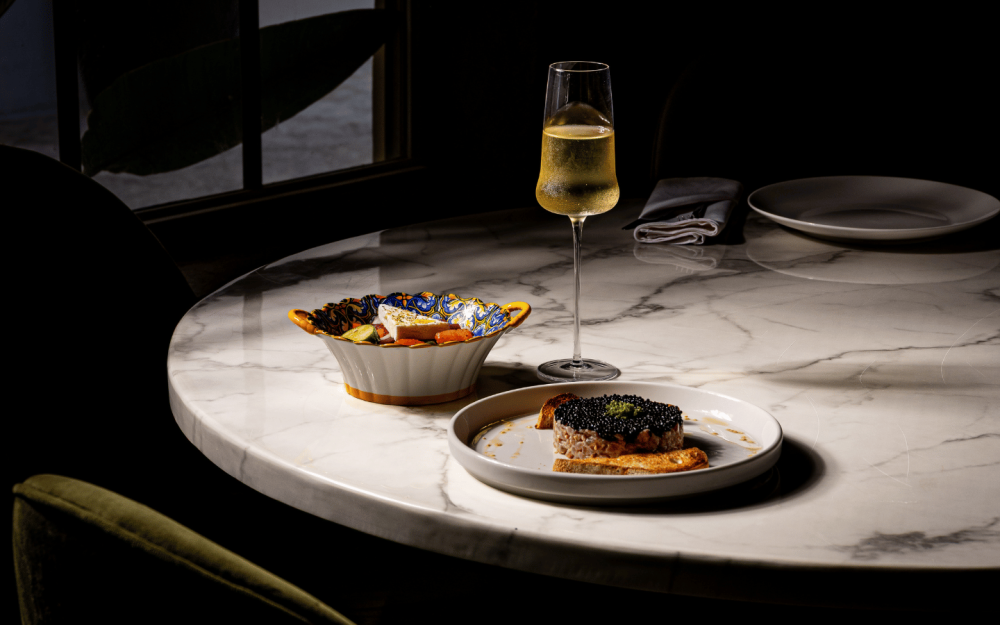 Fresh tuna tartare with caviar and a vibrant Greek salad, showcasing the bright flavors of the Mediterranean.