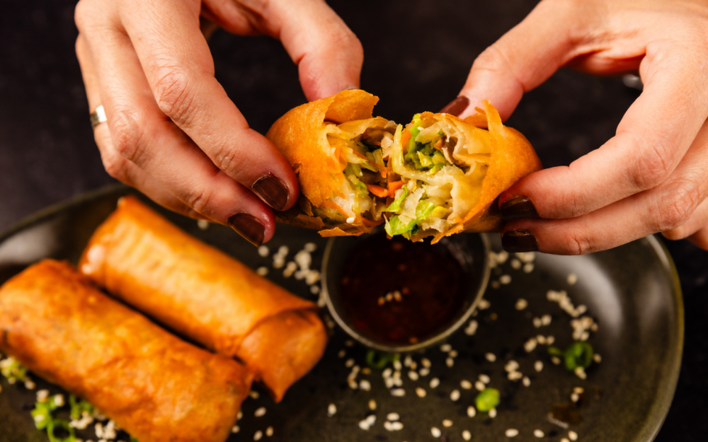 Crispy Vegetarian Spring rolls filled with fresh veggies and herbs, served with a tangy dipping sauce.
