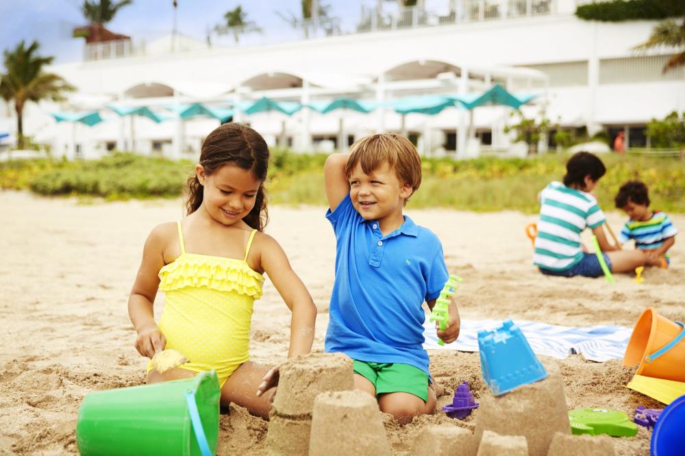 Two kids enjoying beach.