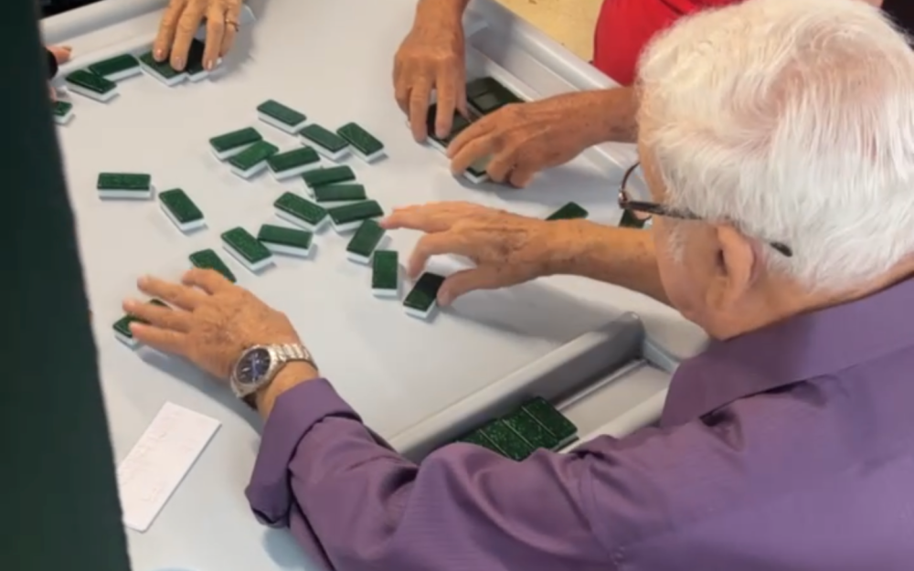 Guests experience the tradition of dominoes, a beloved part of Miami’s Cuban culture, during Key2MIA’s Calle Ocho Experience in Little Havana.