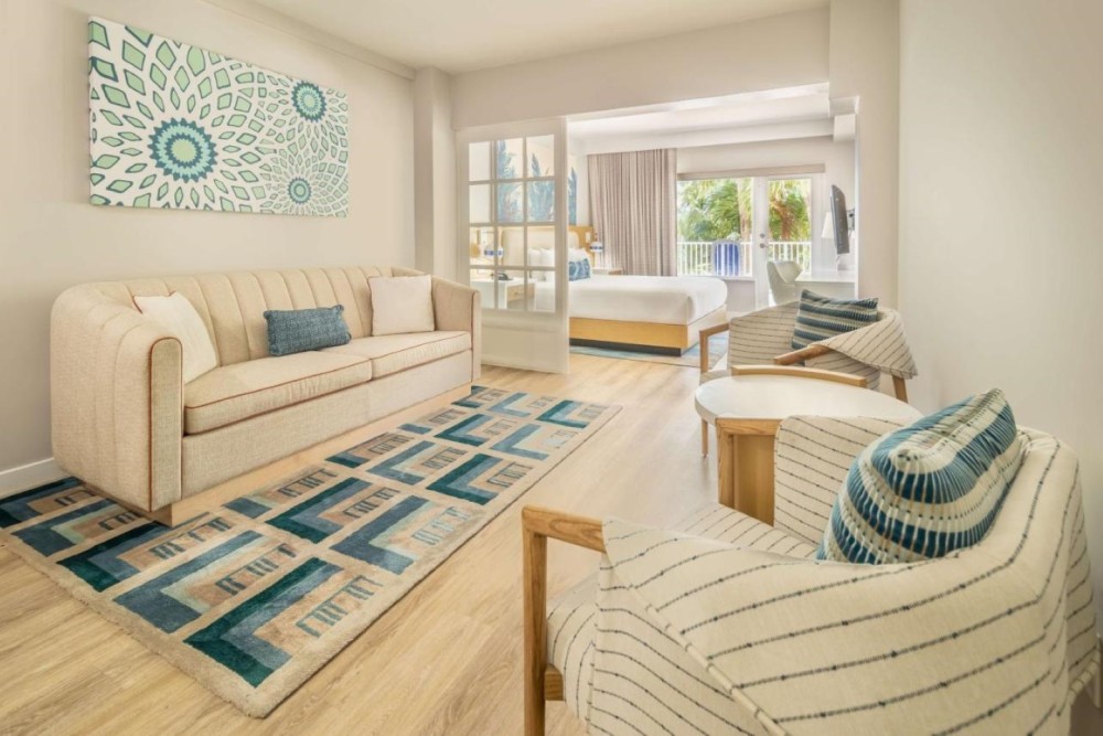 Pool view studio with a king bed, balcony, sitting area and a microwave