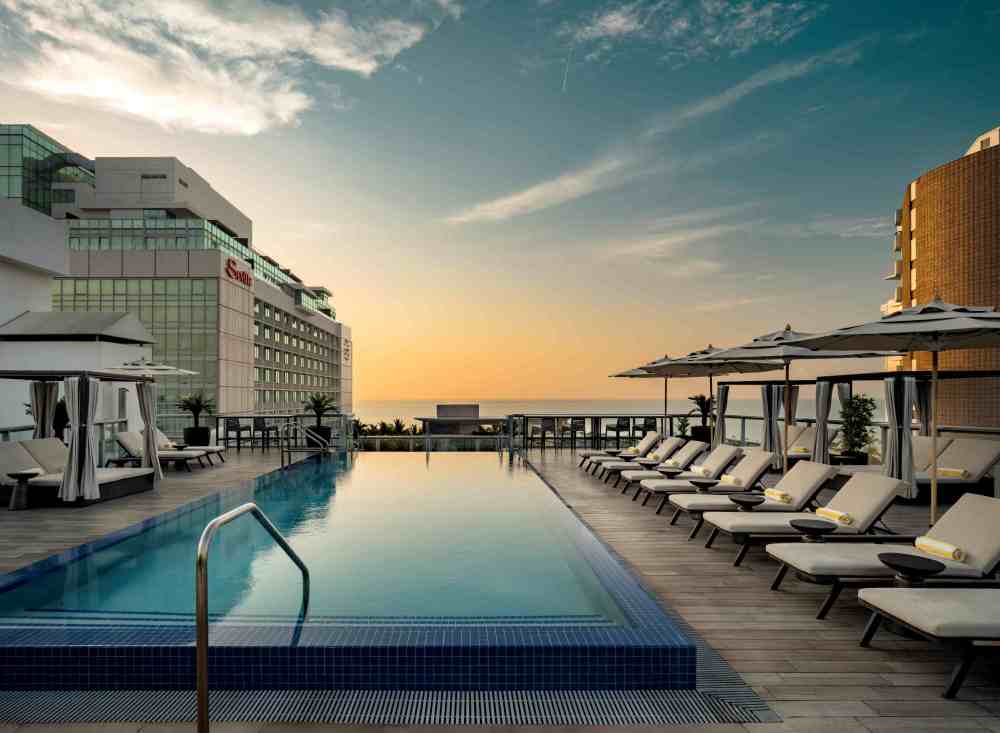 Rooftop pool with ocean views, cabanas, and loungers for a relaxed Miami Beach day.