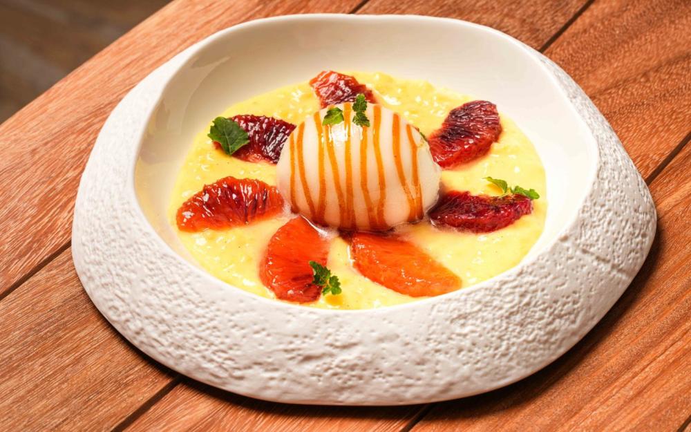 Signature saffron rice pudding topped with blood orange and lemon sorbet—bold, bright, and beautifully balanced.