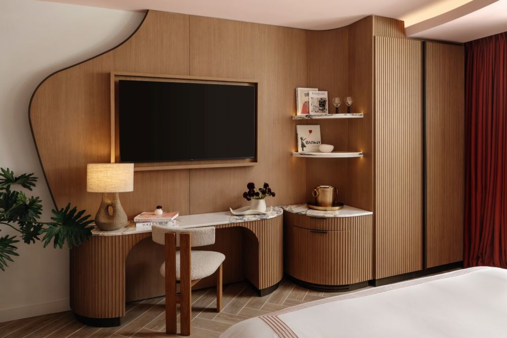 Guestroom TV and Work Desk Area with Shelving and Closet