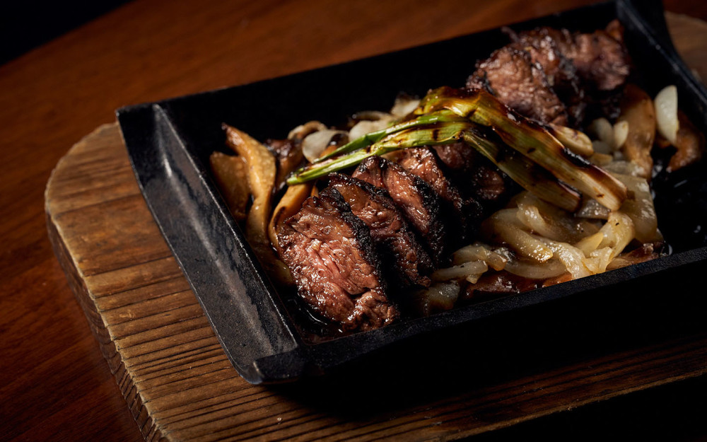 A succulent highlight of the menu, the Mishima Wagyu hanger steak is expertly grilled to bring out its rich marbling and deep, buttery flavors.