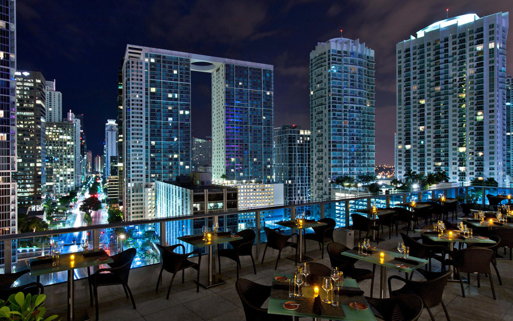 You are in Miami, dine under the stars or enjoy the cocktail bar on the patio