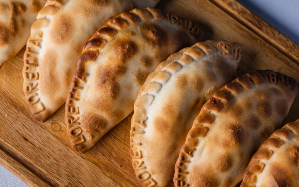 Our Argentinian Empanada is available in spinach & cheese, chicken, beef, or ham & cheese, each offering a mouthwatering filling wrapped in a golden, flaky pastry shell.