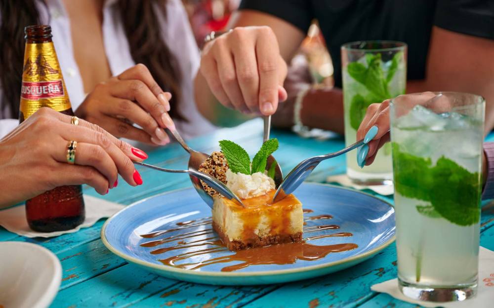 Friends sharing an Arroz con Leche Cheesecake