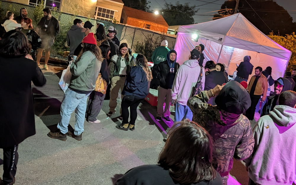 Nighttime meeting in the parking lot of the gallery.