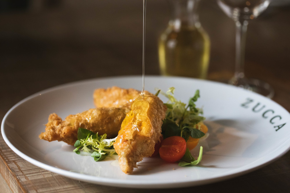 Fried zucchini flowers stuffed with prawns and stracciatella.