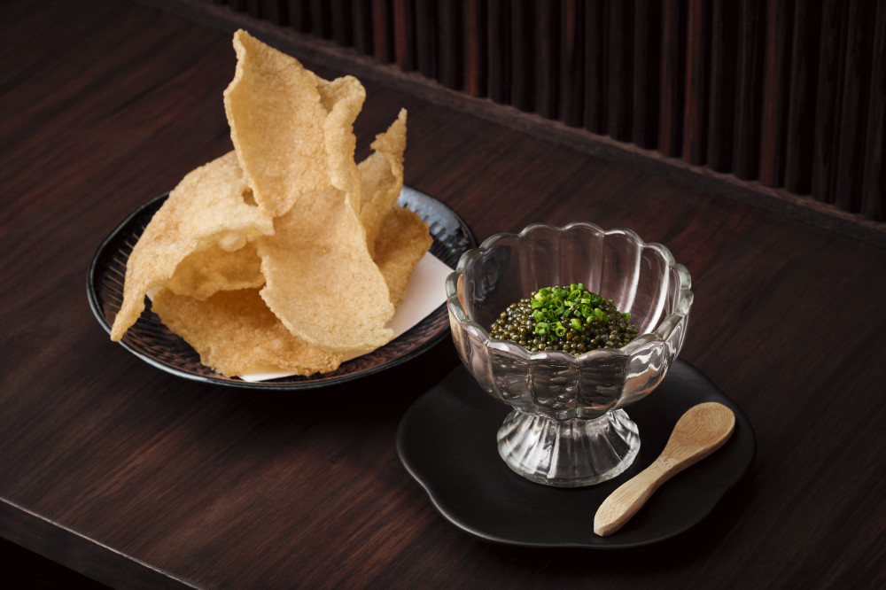 Luxurious caviar, served with a side of house-made crispy rice chips.