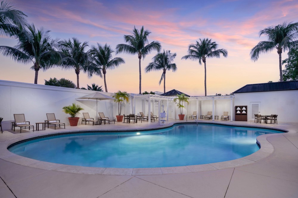 As dusk falls, our pool oasis becomes a tranquil haven. Enjoy the soft evening hues and the whisper of palm leaves in our secluded paradise