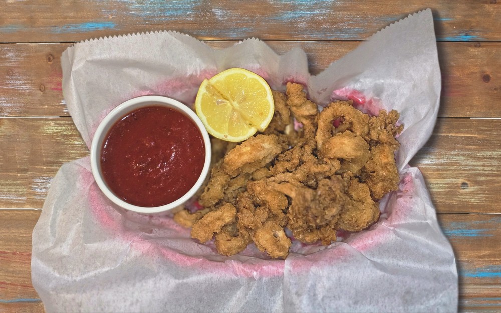 Coated in flour and deep-fried until golden and crispy. Served with lemon wedges and a dipping sauce, like marinara.