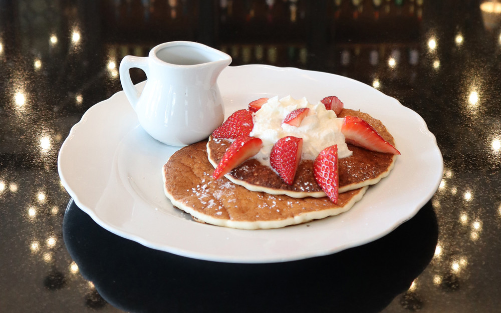 Pancake breakfast with whipped cream and strawberries