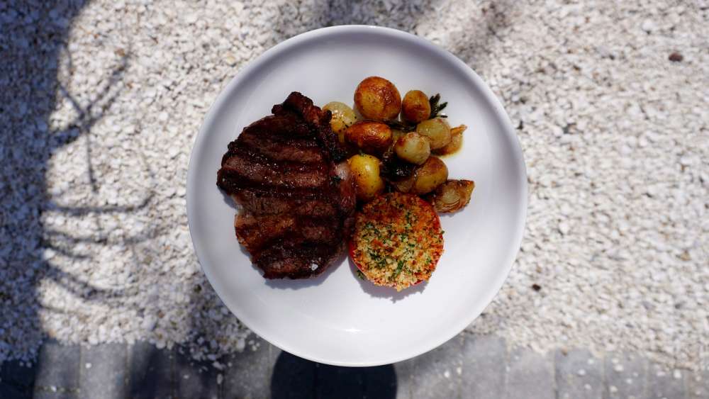Charcoal Grilled 12oz Grass Fed Uruguayan Rib Eye
 roasted marble potatoes & cipollini onions, tomato Provençal