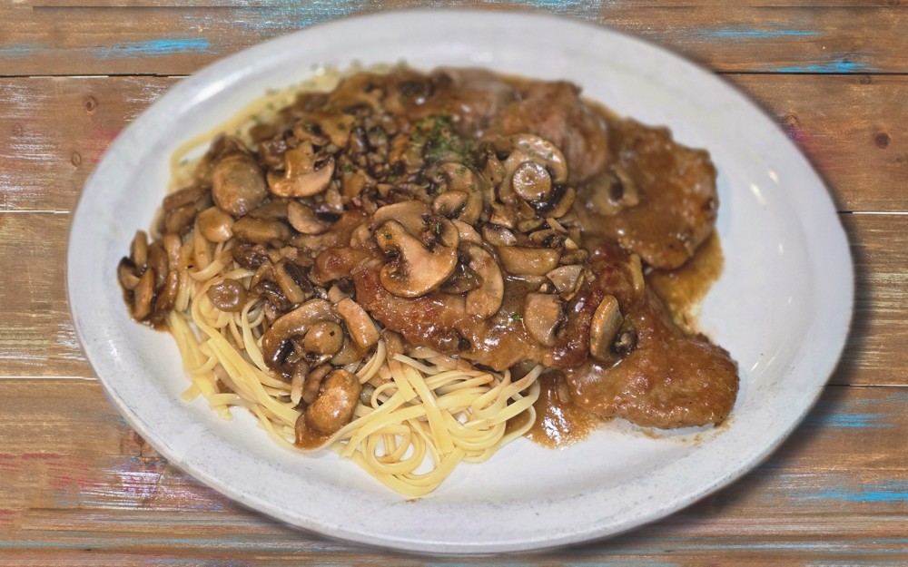 A classic Italian-American dish featuring pan-fried chicken cutlets in a rich, savory sauce made with Marsala wine and mushrooms.