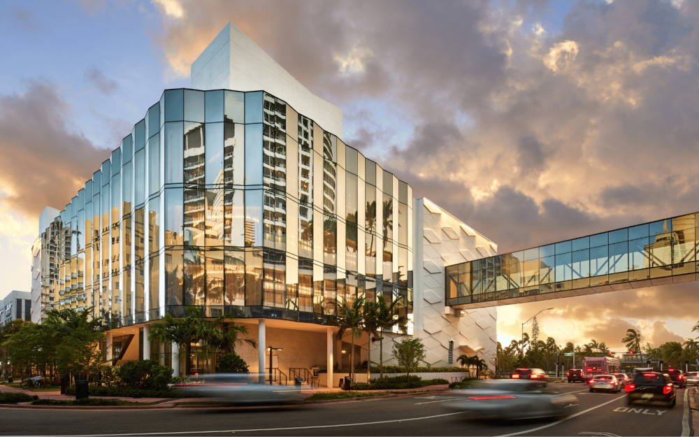 Exterior South Drive at dusk with illuminated façade and vibrant Miami Beach atmosphere.