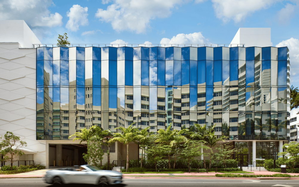 Collins Avenue façade with reflective glass and designated ground floor entry.