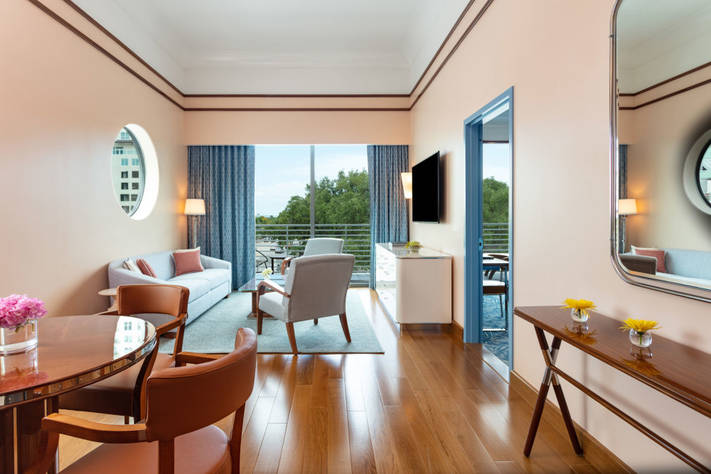 Spacious 700 sq ft. one-bedroom suite with a King bed, living room, 1.5 baths, and furnished balcony with city views.