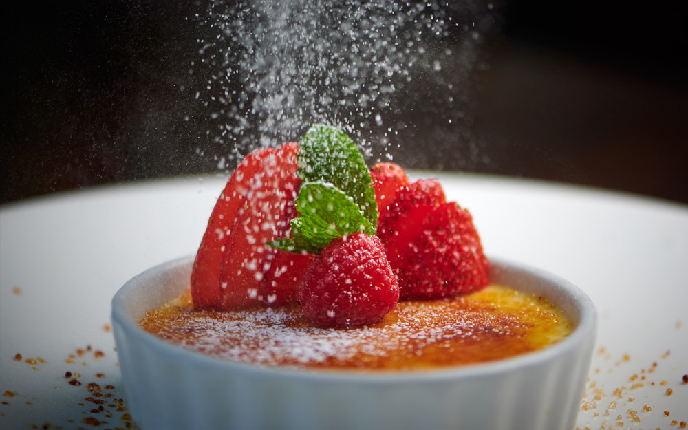 A traditional vanilla custard topped with caramelized brown sugar and fresh berries.