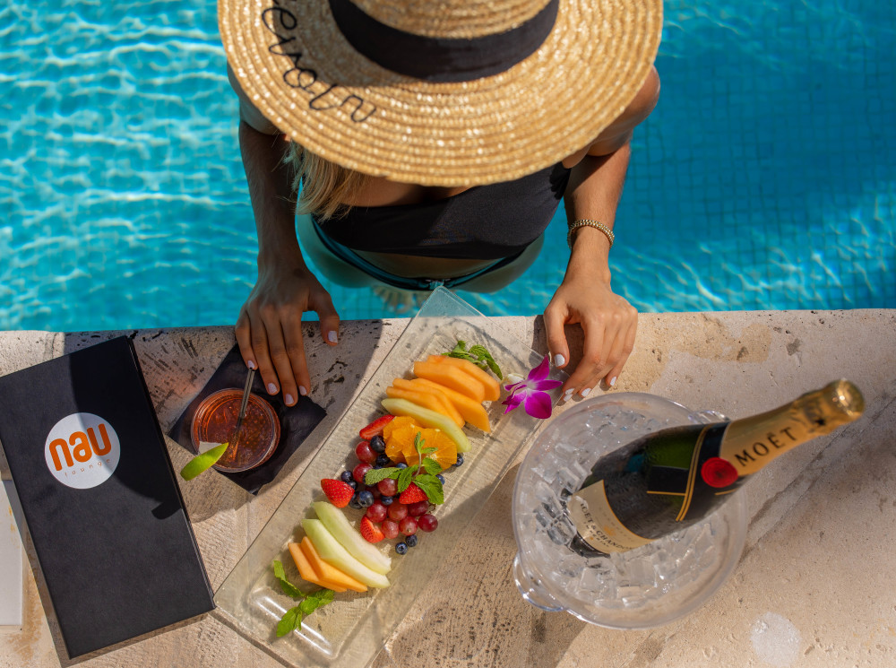Enjoy the pool with a serving of fresh fruit and chilled champagne