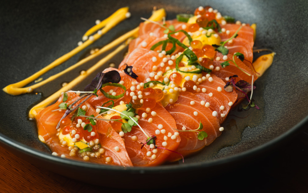Scottish Salmon, Ikura, Scallions, Arare, Topped w/ Yuzu Citrus Sauce and Aji Amarillo Mayo