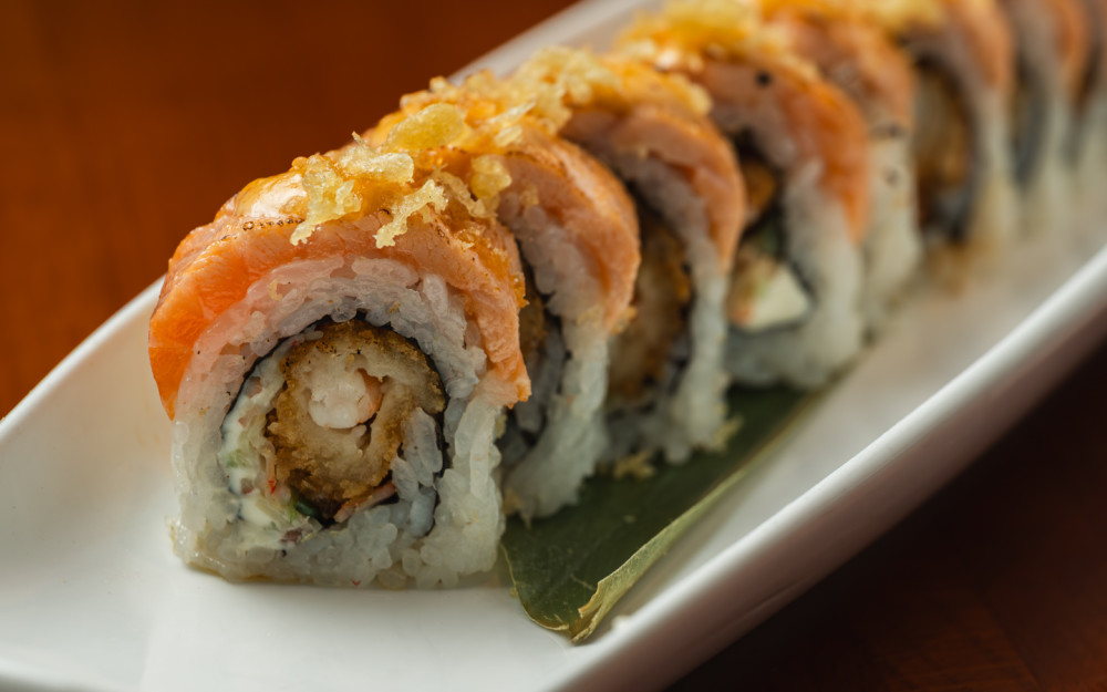 Crispy Shrimp, Osaki Kani Salad, Cream Cheese, Topped w/ Seared Scottish Salmon, Tempura Flakes, Spicy Mayo, Eel Sauce, NorI