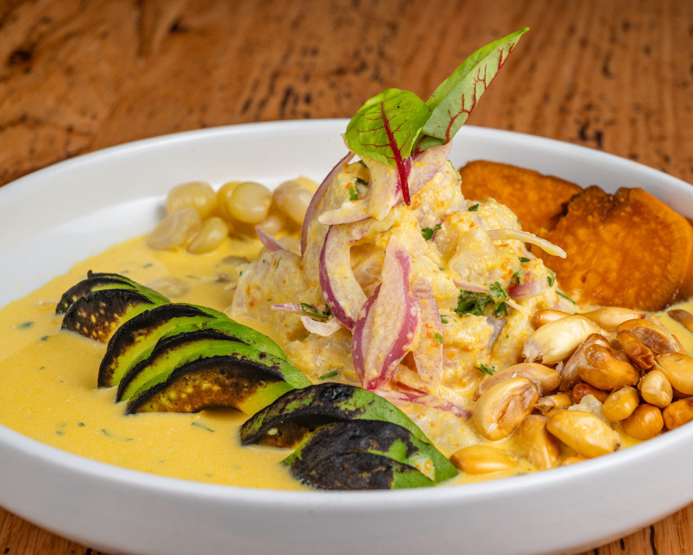 Fresh fish ceviche in yellow pepper tiger’s milk with choclo, avocado, and sweet potato.