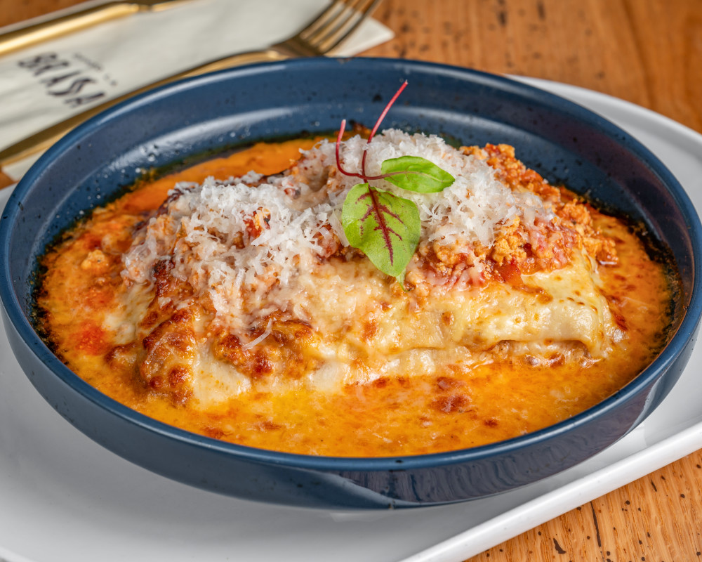 House-made lasagna layered with rotisserie chicken ragù, creamy béchamel, and melted cheese